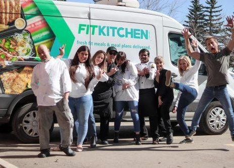 Fit Kitchen team posing in front of the company Van