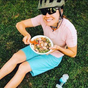 Cyclist having healthy meal wearing a helmet