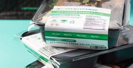 Stack of pre-packaged Fit Kitchen meals