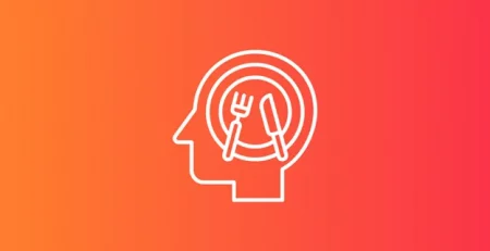 Silhouette of a head with a plate, fork, and knife icon inside, on a gradient orange-red background